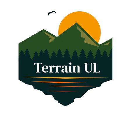 Image of Terrain UL logo with mountains, sun, bird flying and lake.