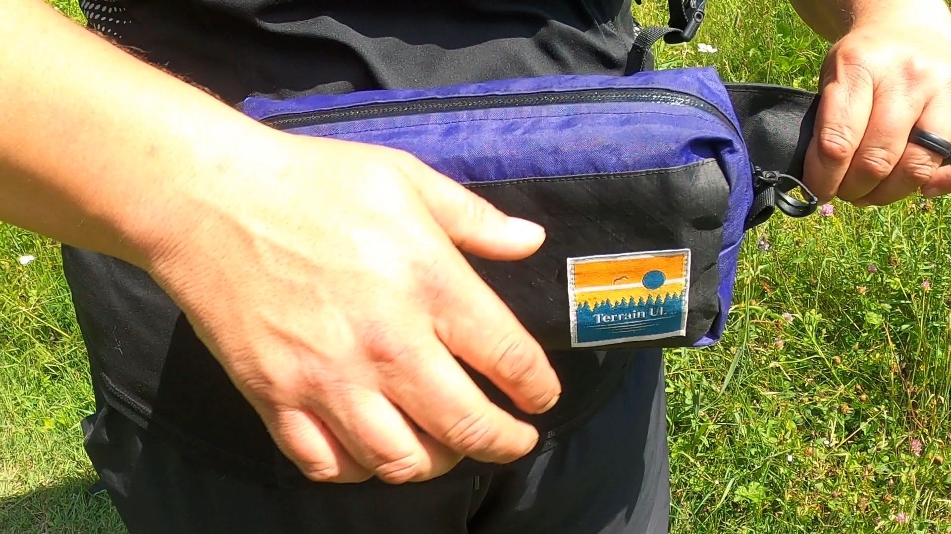 Load video: Dettach fanny pack buckles from hip belt and attach buckles to Free Range backpack and tighten.